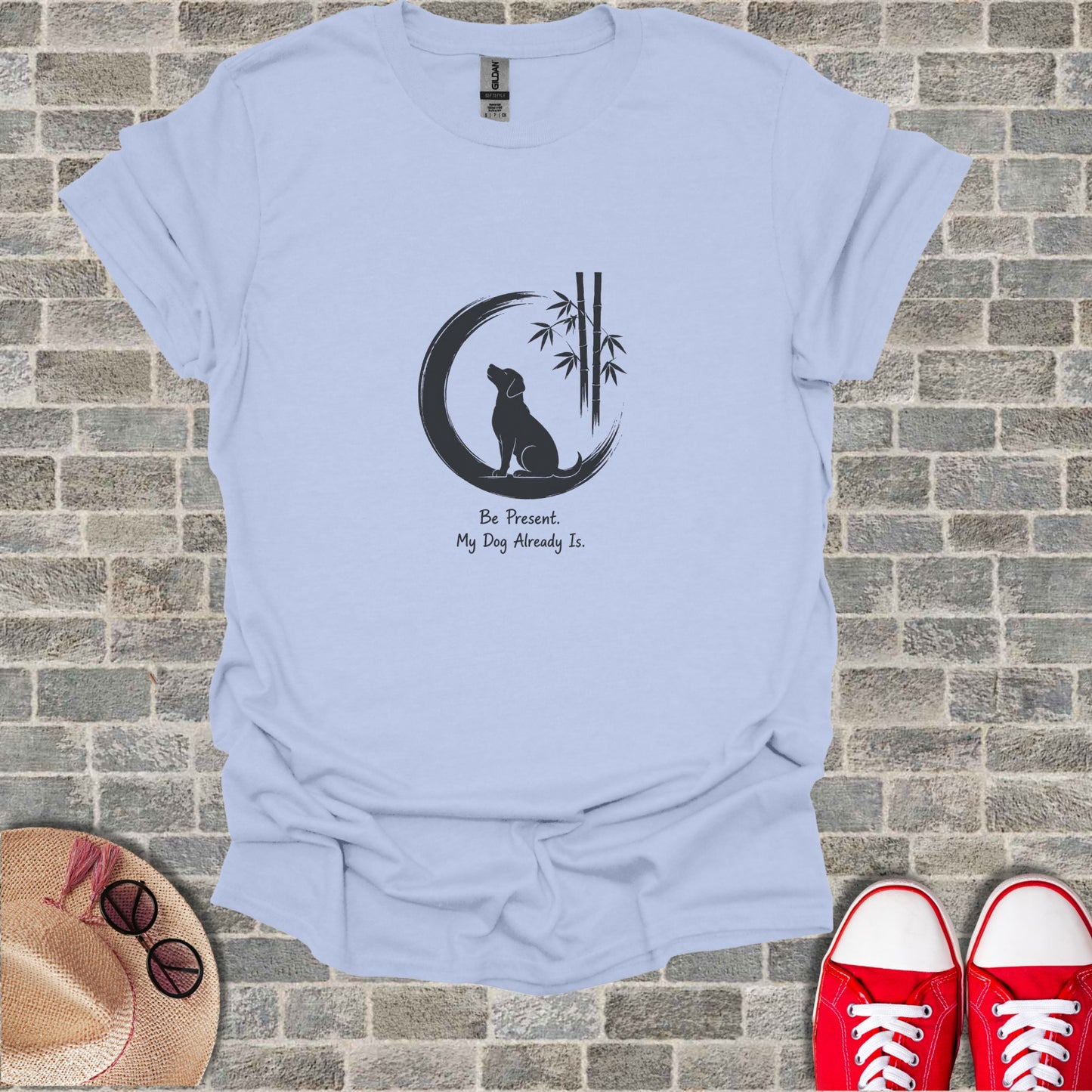 Light blue t-shirt with dog silhouette, bamboo, and "Be Present. My Dog Already Is." text.