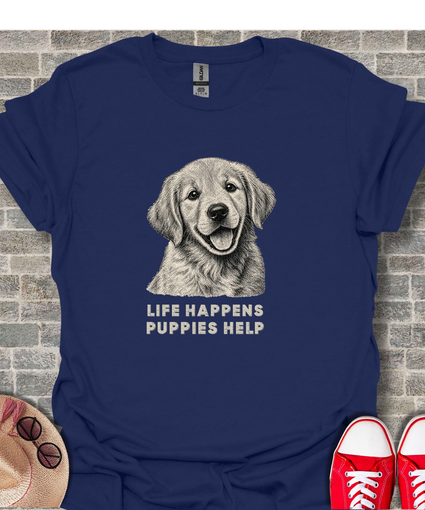 Navy t-shirt with sketch of smiling golden retriever and text "LIFE HAPPENS PUPPIES HELP."