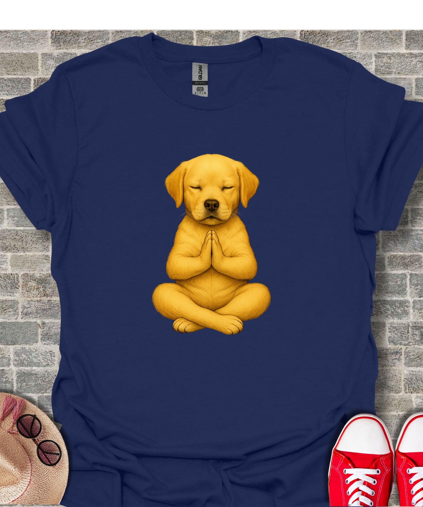Yellow Labrador puppy meditating in a lotus pose on a navy t-shirt.
