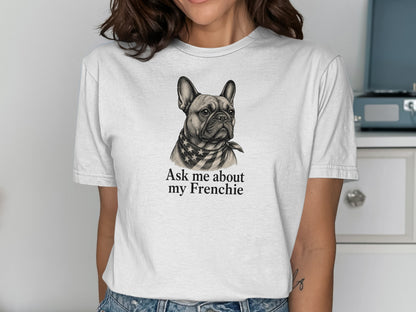 White t-shirt with a graphic of a French Bulldog wearing a star-spangled bandana and text.