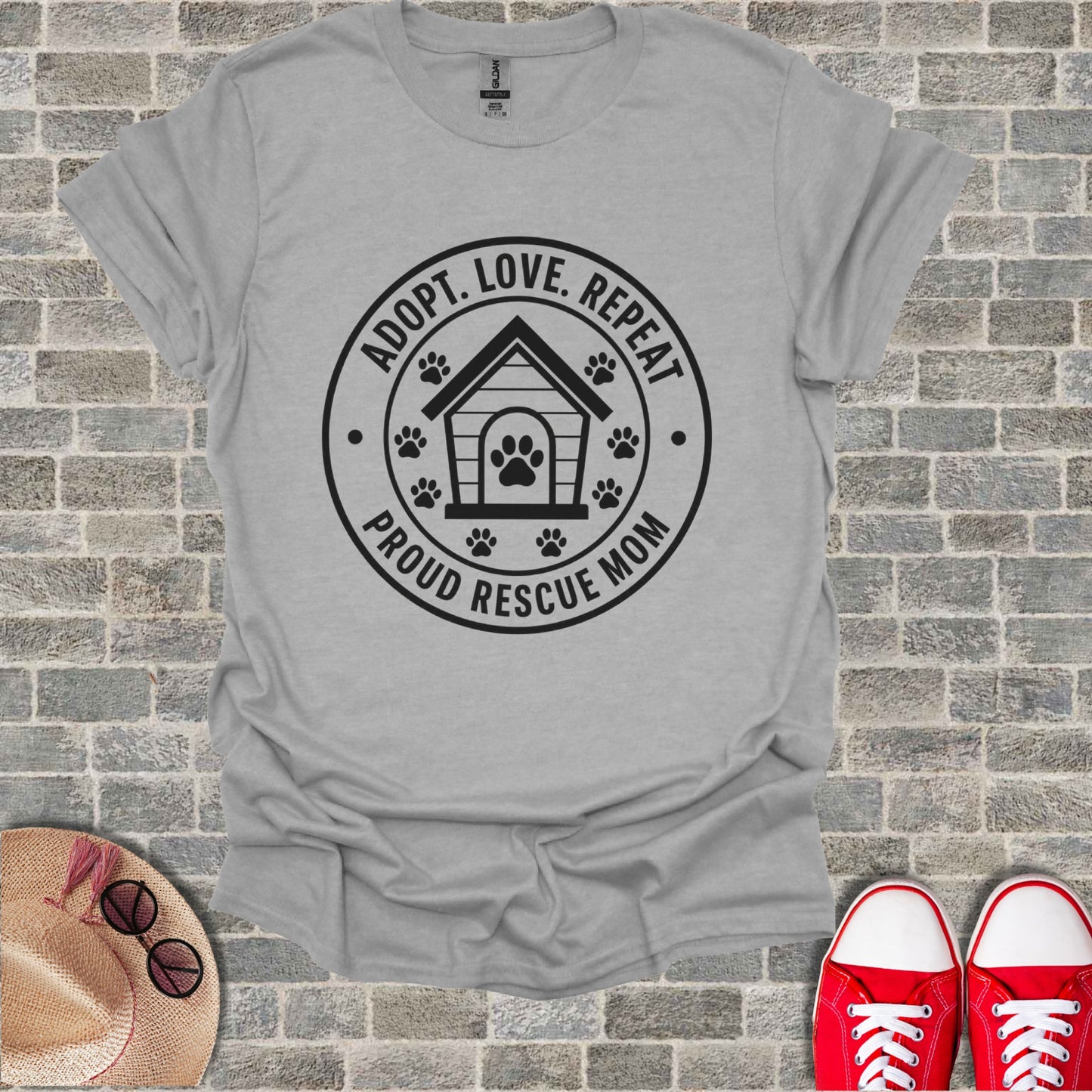 Grey t-shirt with black graphic: "Adopt. Love. Repeat. Proud Rescue Mom."