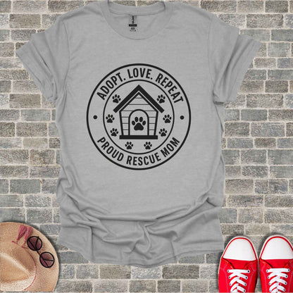Grey t-shirt with black graphic: "Adopt. Love. Repeat. Proud Rescue Mom."