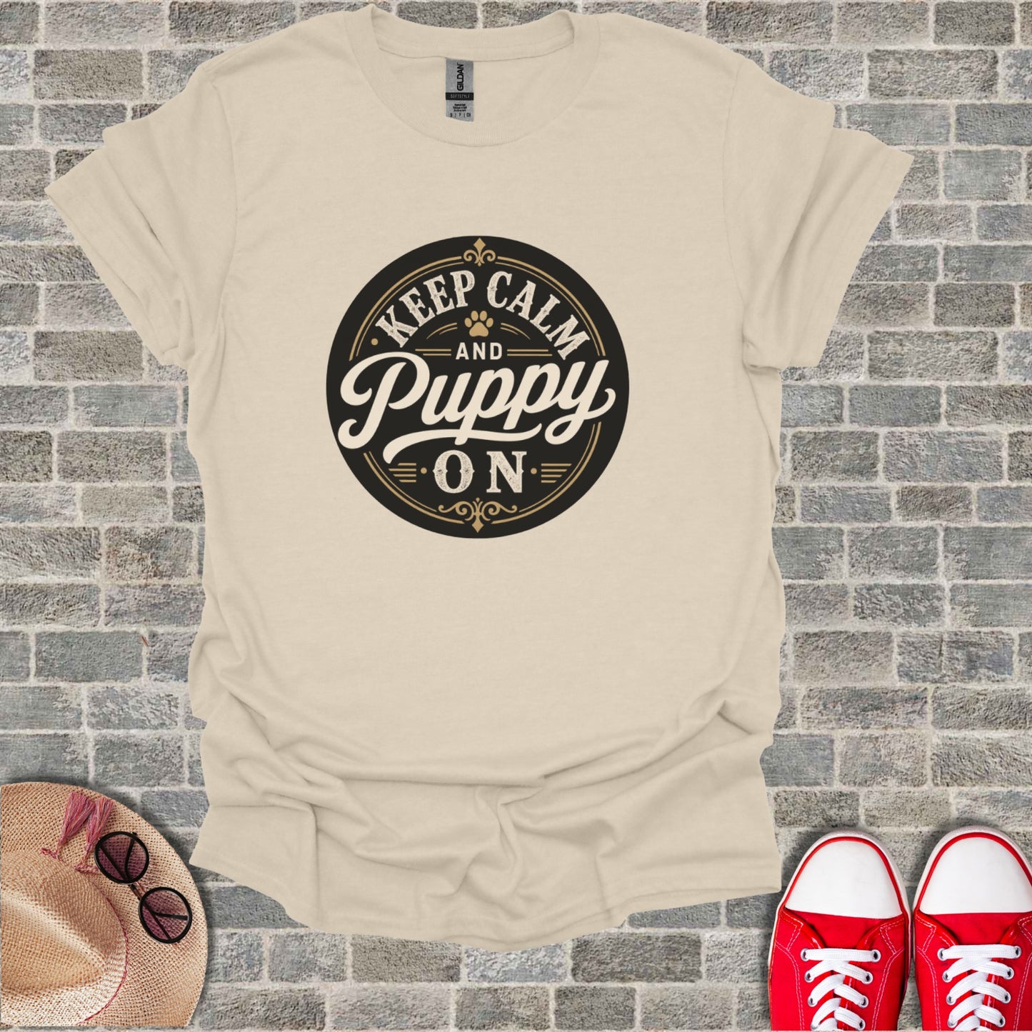 Cream t-shirt with "Keep Calm and Puppy On" text in circular emblem.