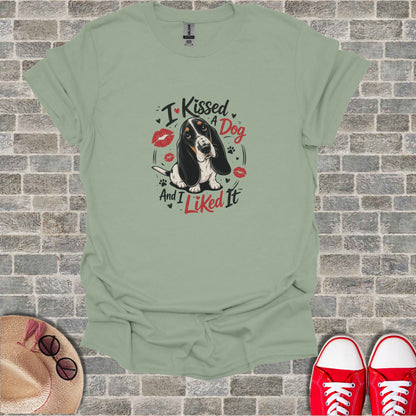 Mint green t-shirt with "I Kissed A Dog And I Liked It" and kissing lips graphic.