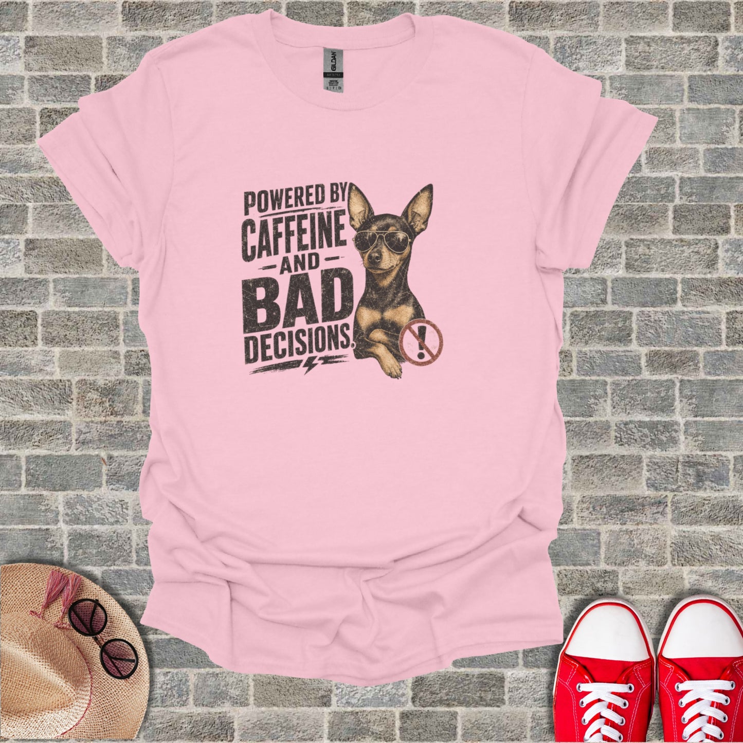 Pink t-shirt with distressed graphic of dog, sunglasses, and text "Powered by Caffeine and Bad Decisions".