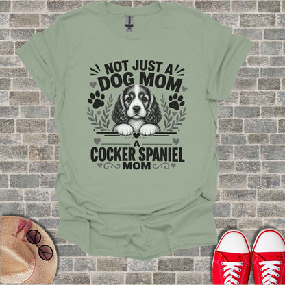 Light green t-shirt with "Not Just a Dog Mom, A Cocker Spaniel Mom" text and dog graphic.