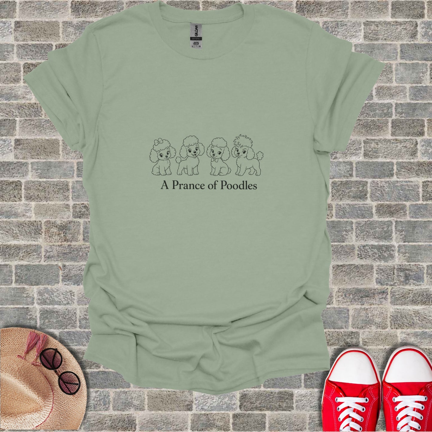 Light green t-shirt with line drawing of four poodles and text "A Prance of Poodles".