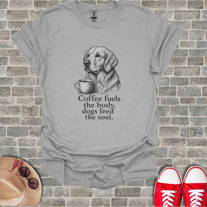 Grey t-shirt with a sketch of a golden retriever holding a coffee cup and the text "Coffee fuels the body, dogs feed the soul."