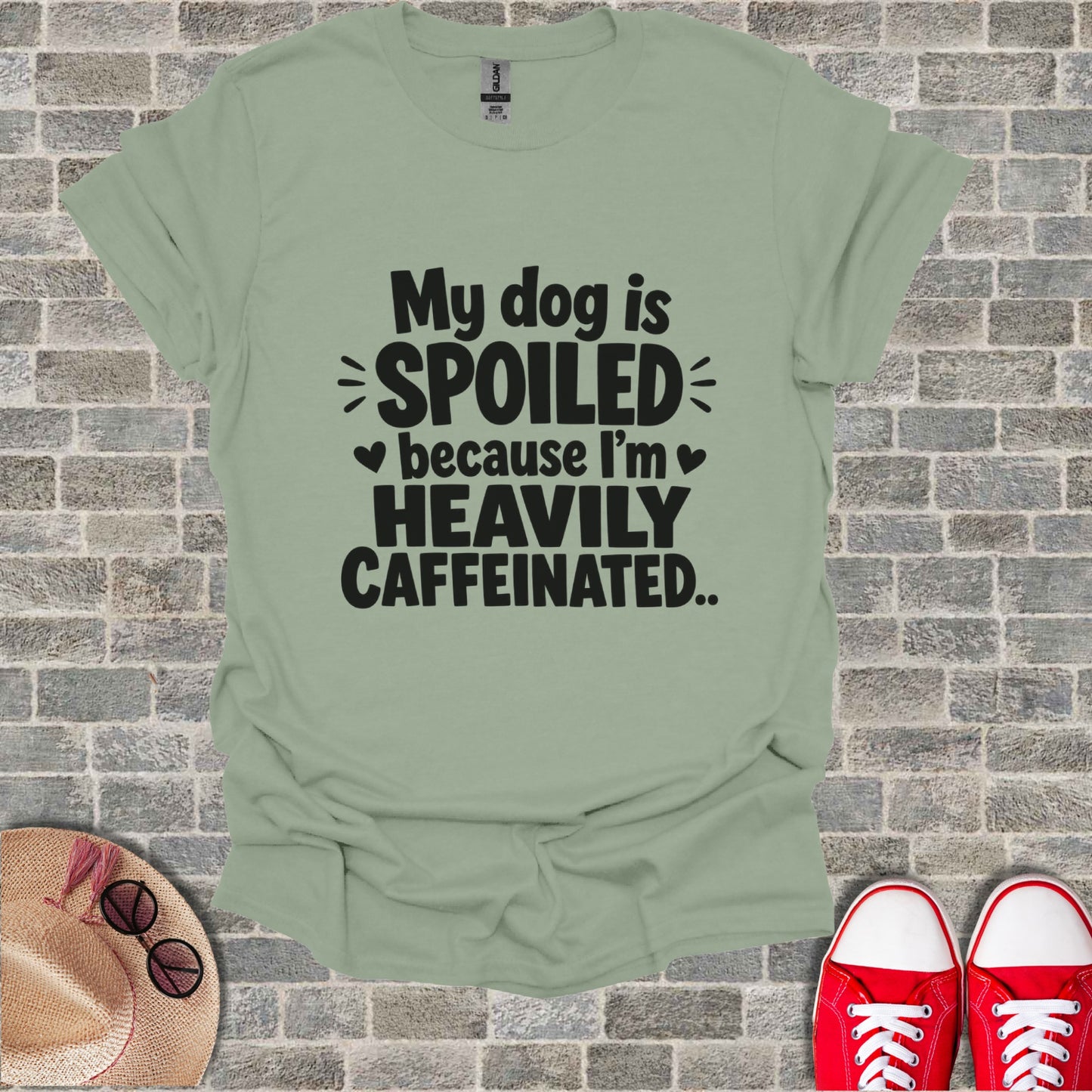 Light green t-shirt with "My dog is spoiled because I'm heavily caffeinated" text.