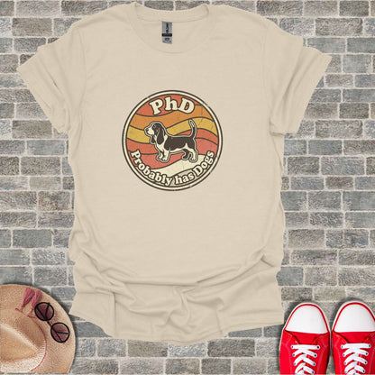 Cream t-shirt with "PhD Probably has dogs" and a dog illustration.