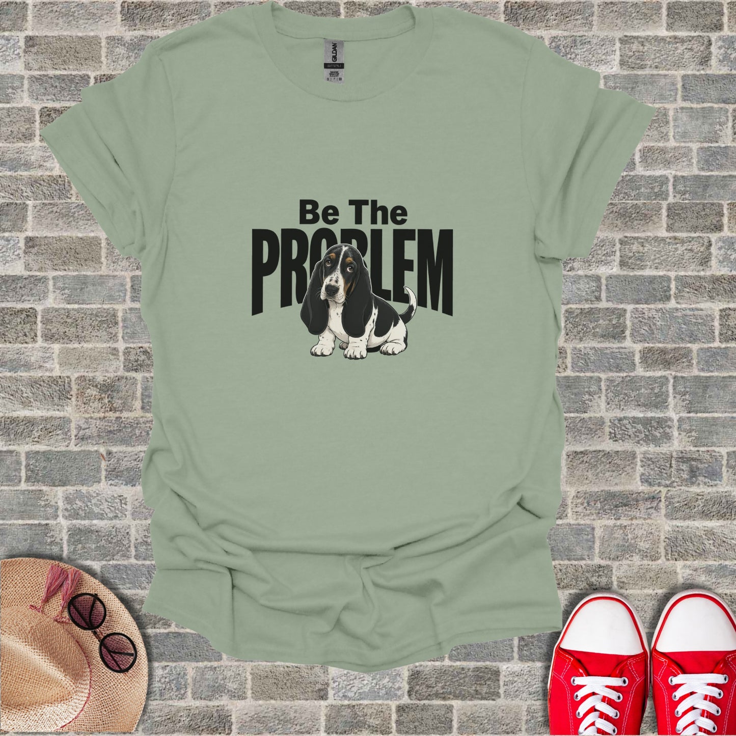 Sage green t-shirt with "Be The PROBLEM" and a basset hound graphic.