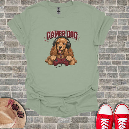 Brown dog wearing headphones, holding a video game controller, text reads "Gamer Dog".