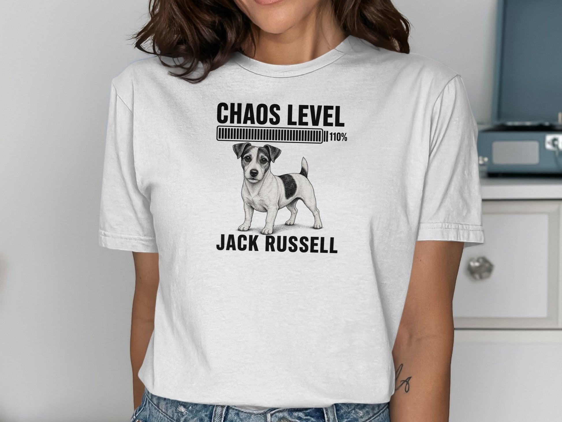 White t-shirt with black illustration of a Jack Russell dog and "Chaos Level 110%" text.