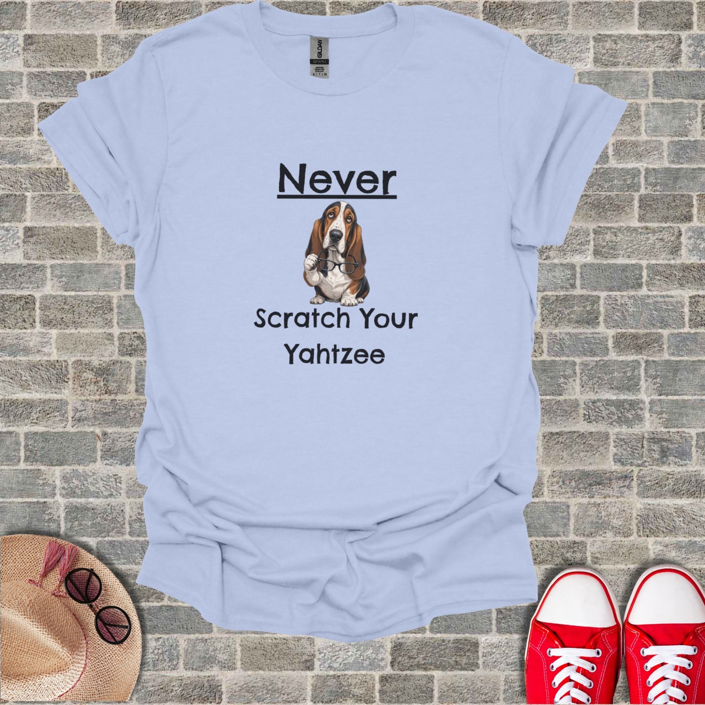 Light blue t-shirt with a Basset Hound and "Never Scratch Your Yahtzee" text.