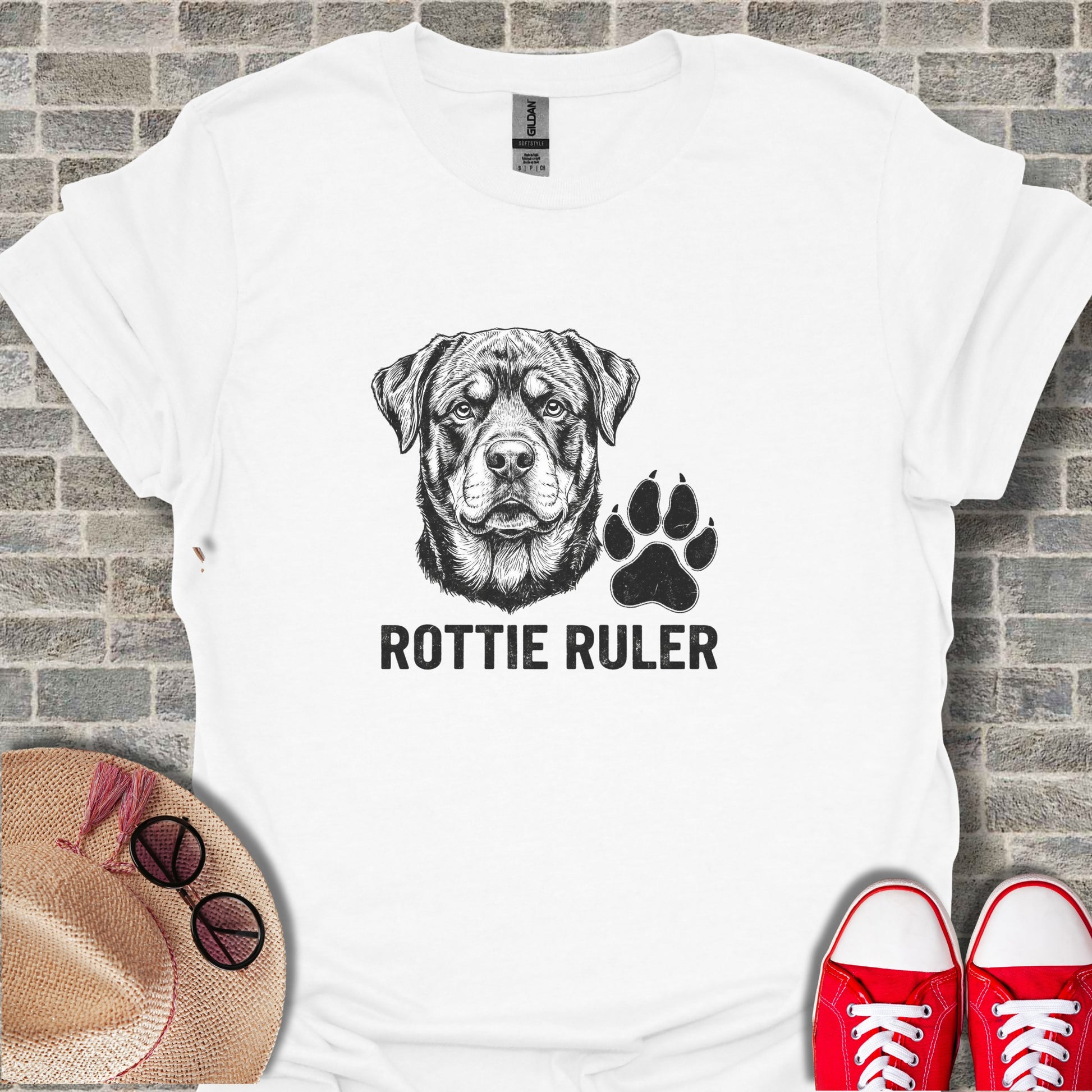 Rottweiler dog head and paw print graphic on white t-shirt.