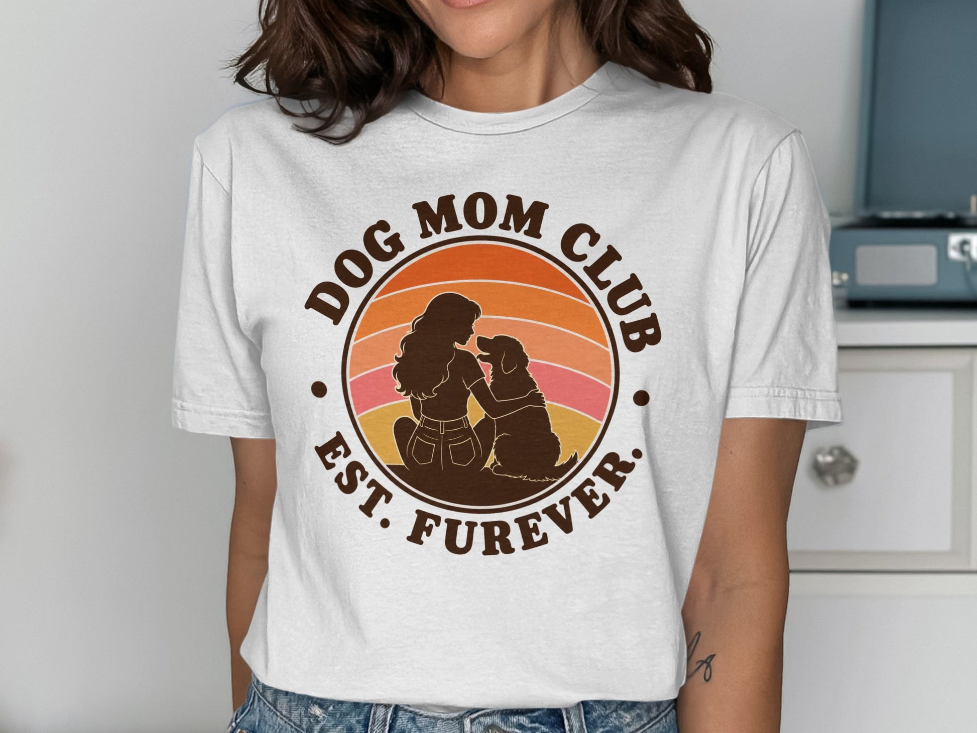 Dog Mom Club Est. Furever circular graphic with sunset and silhouettes of woman and dog.
