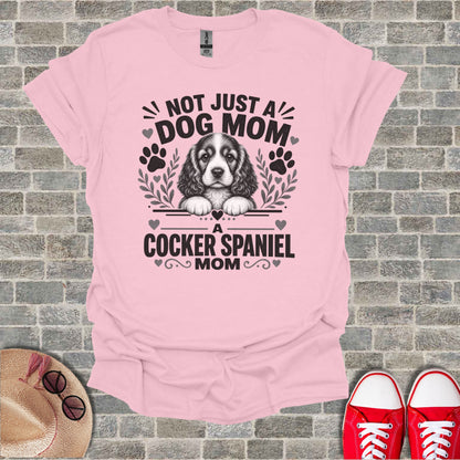 Pink t-shirt with "Not Just A Dog Mom, A Cocker Spaniel Mom" graphic and dog illustration.