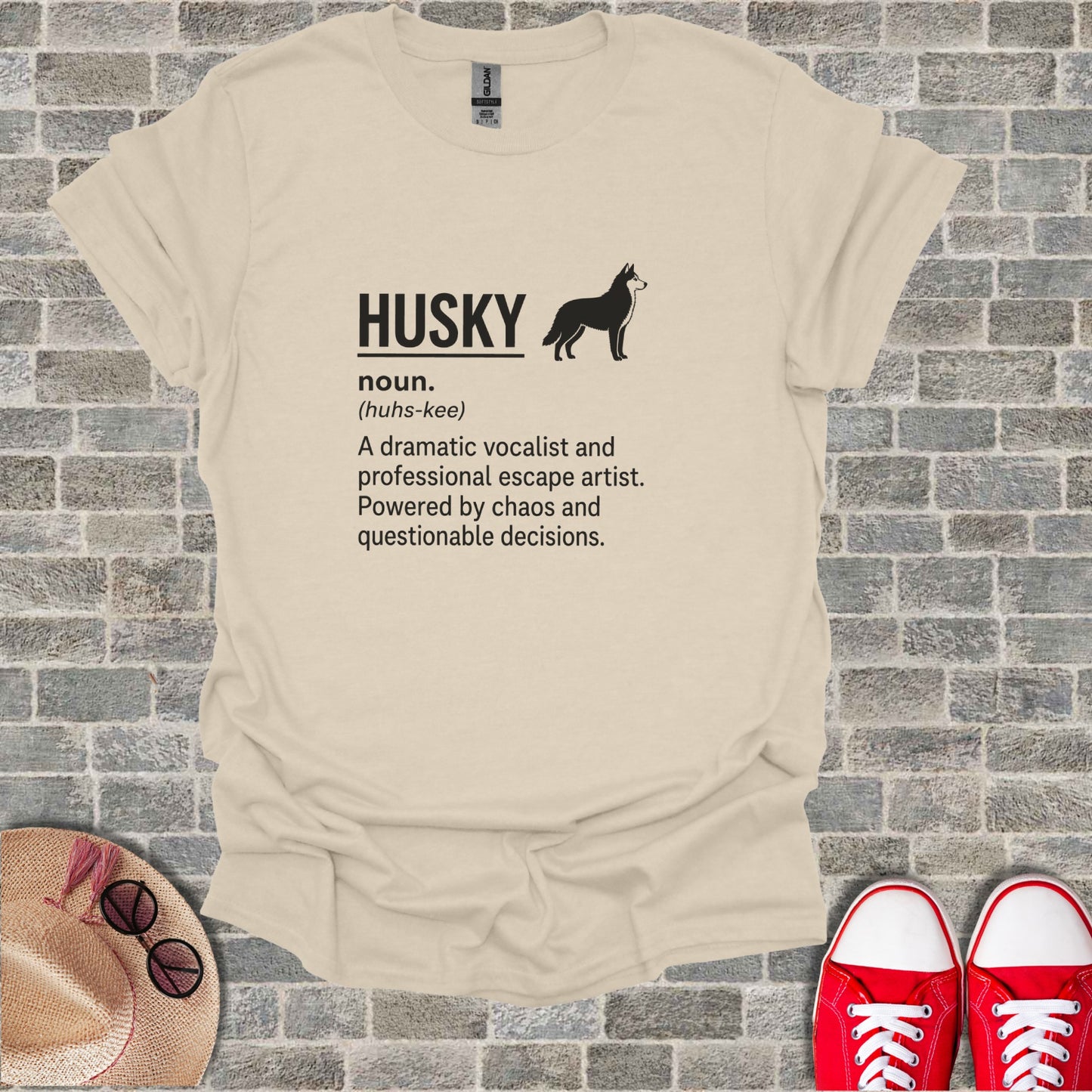 Beige t-shirt with black text "HUSKY (huhs-kee) A dramatic vocalist and professional escape artist."