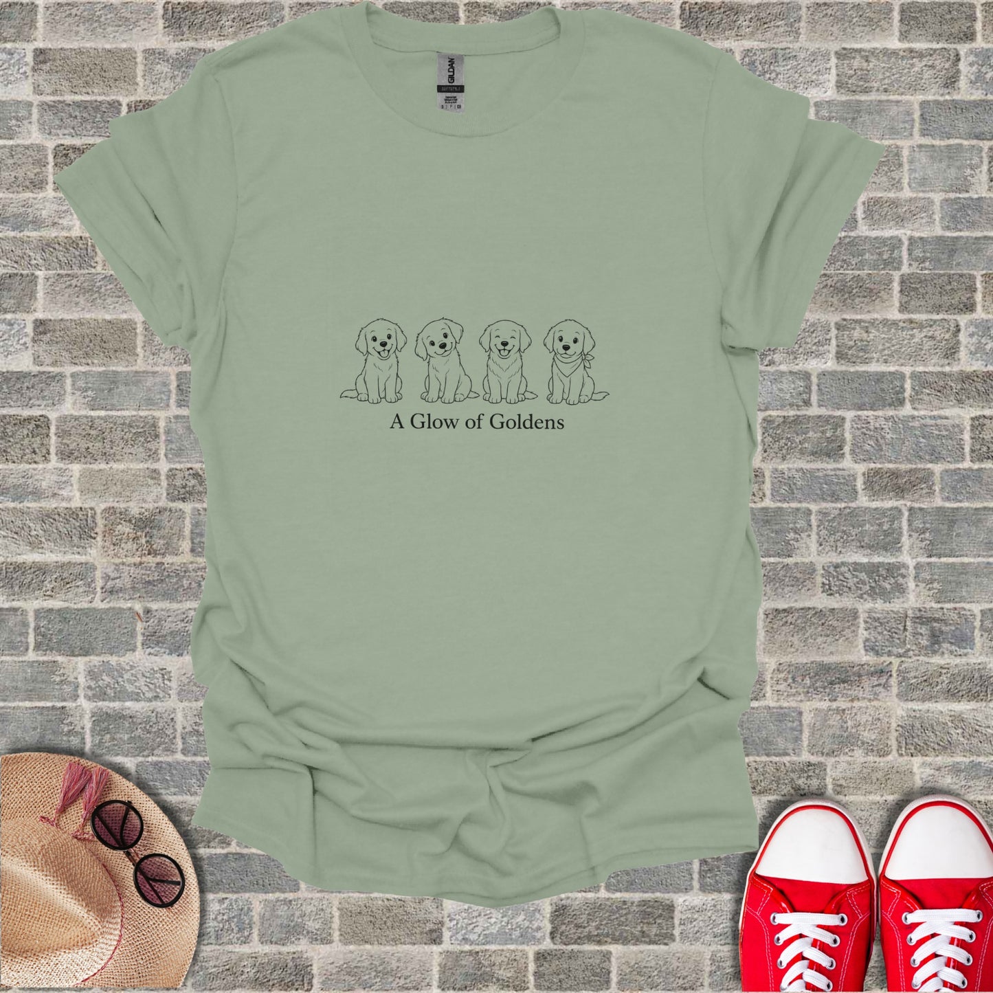 T-shirt with line drawing of four golden retrievers and text "A Glow of Goldens".