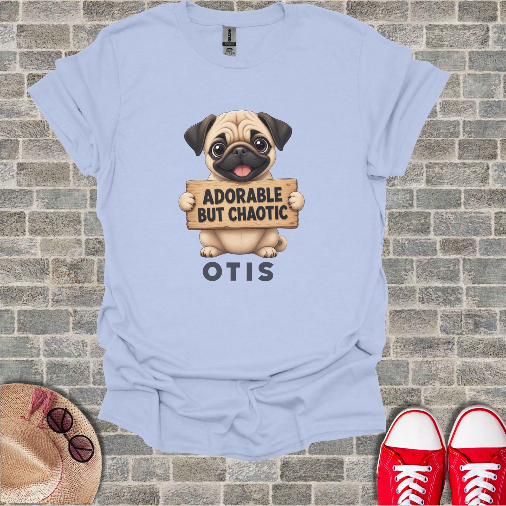 Light blue t-shirt with pug holding "Adorable But Chaotic Otis" sign.