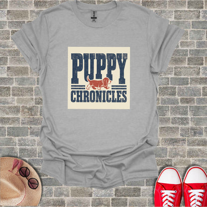 Gray t-shirt with "PUPPY CHRONICLES" text and a dog illustration.