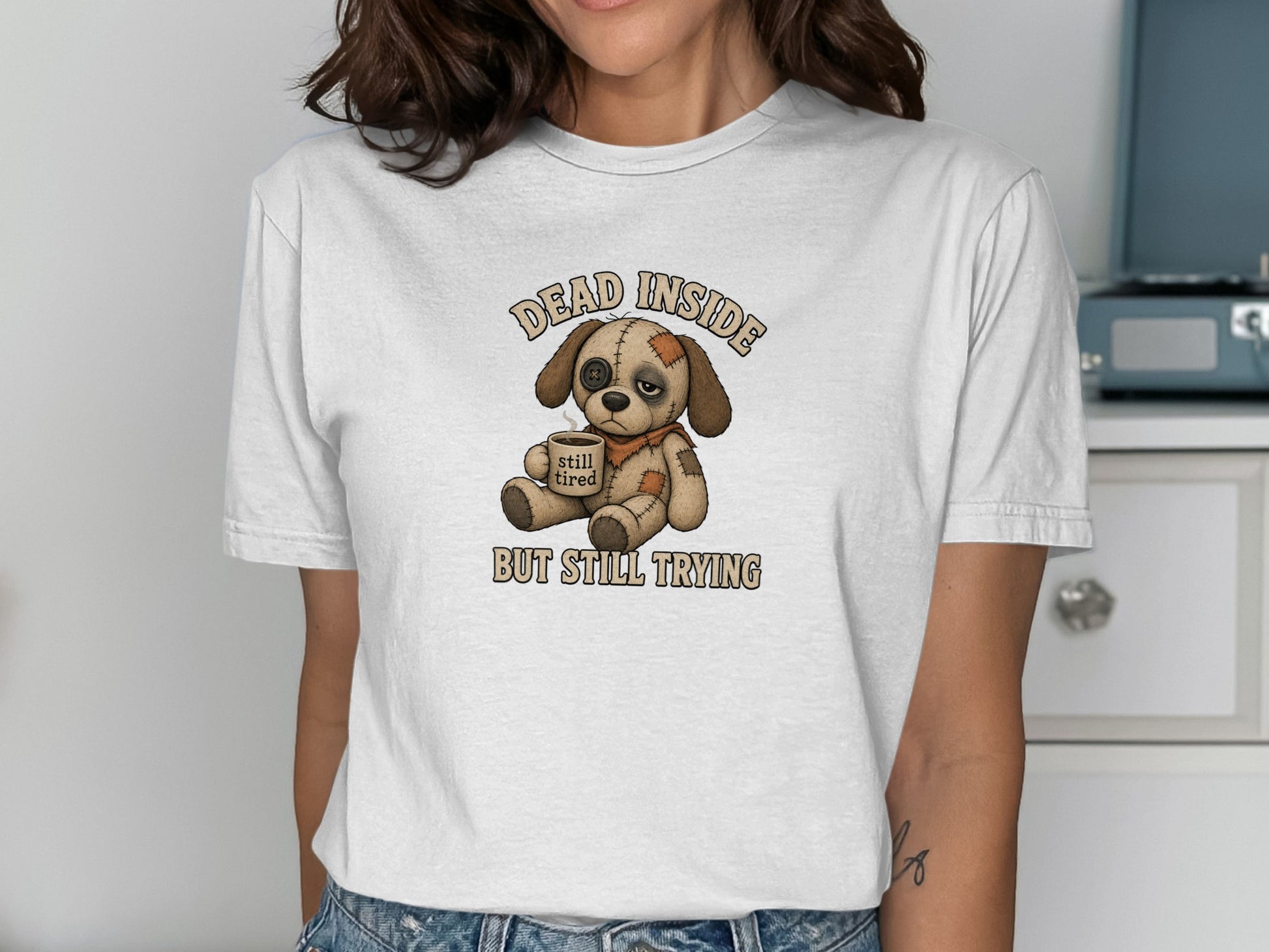 Illustration of a sad dog wearing a bandage, with text "DEAD INSIDE STILL TIRED".