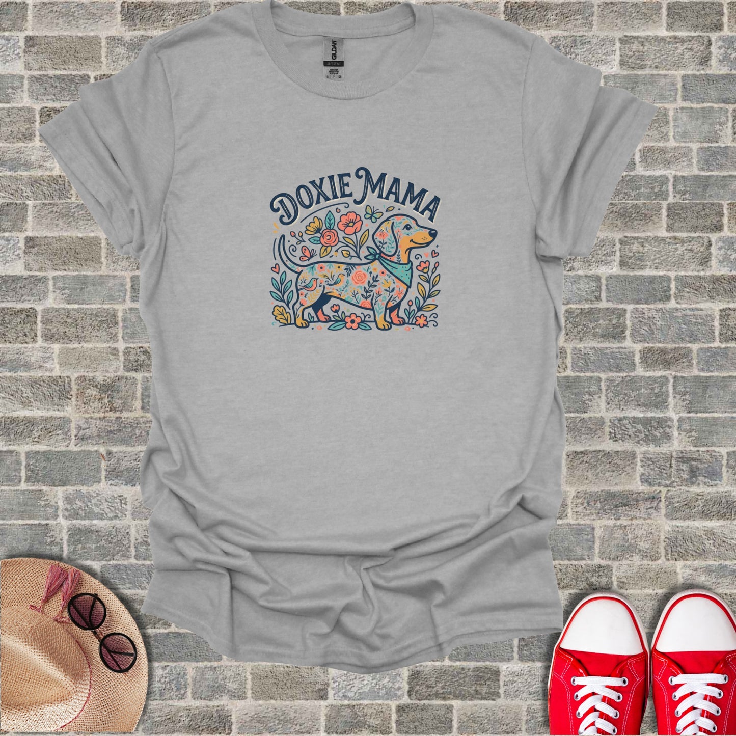 Dachshund with flowers and "Doxie Mama" text on a grey t-shirt.