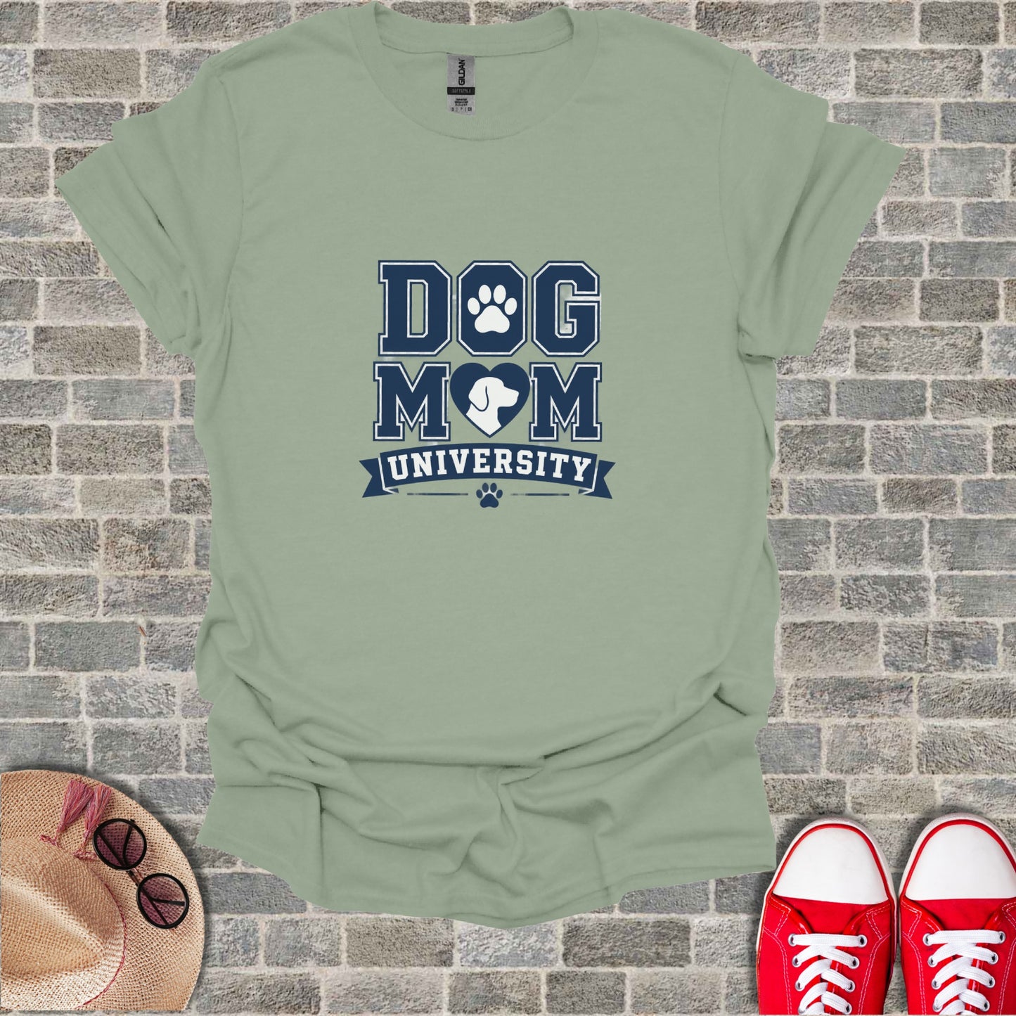"Dog Mom University" text and paw print logo on a light green t-shirt.