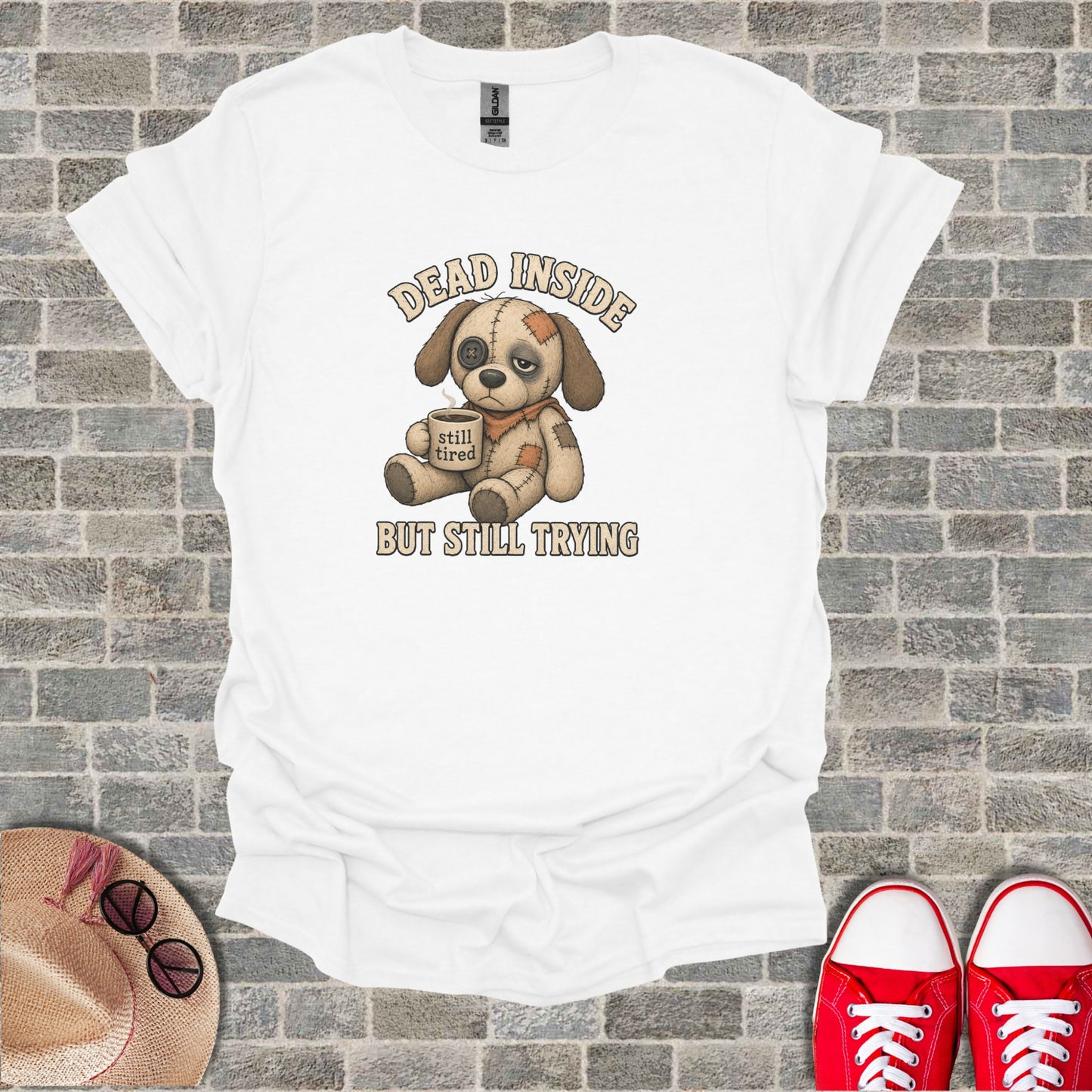 White t-shirt with a cartoon dog wearing an eyepatch holding a coffee cup and text.