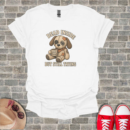 White t-shirt with a cartoon dog wearing an eyepatch holding a coffee cup and text.