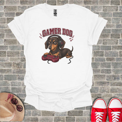 White t-shirt with a dachshund wearing headphones playing a video game.