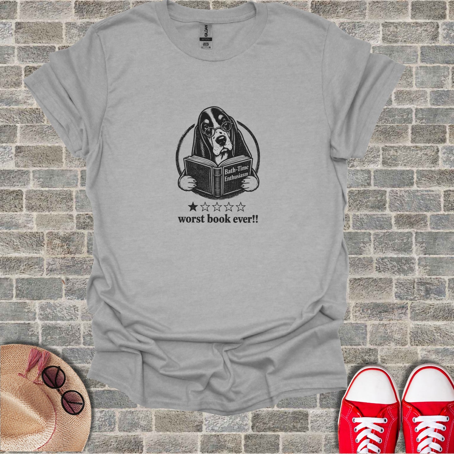 T-shirt with a Bassethound wearing glasses reading a book.
