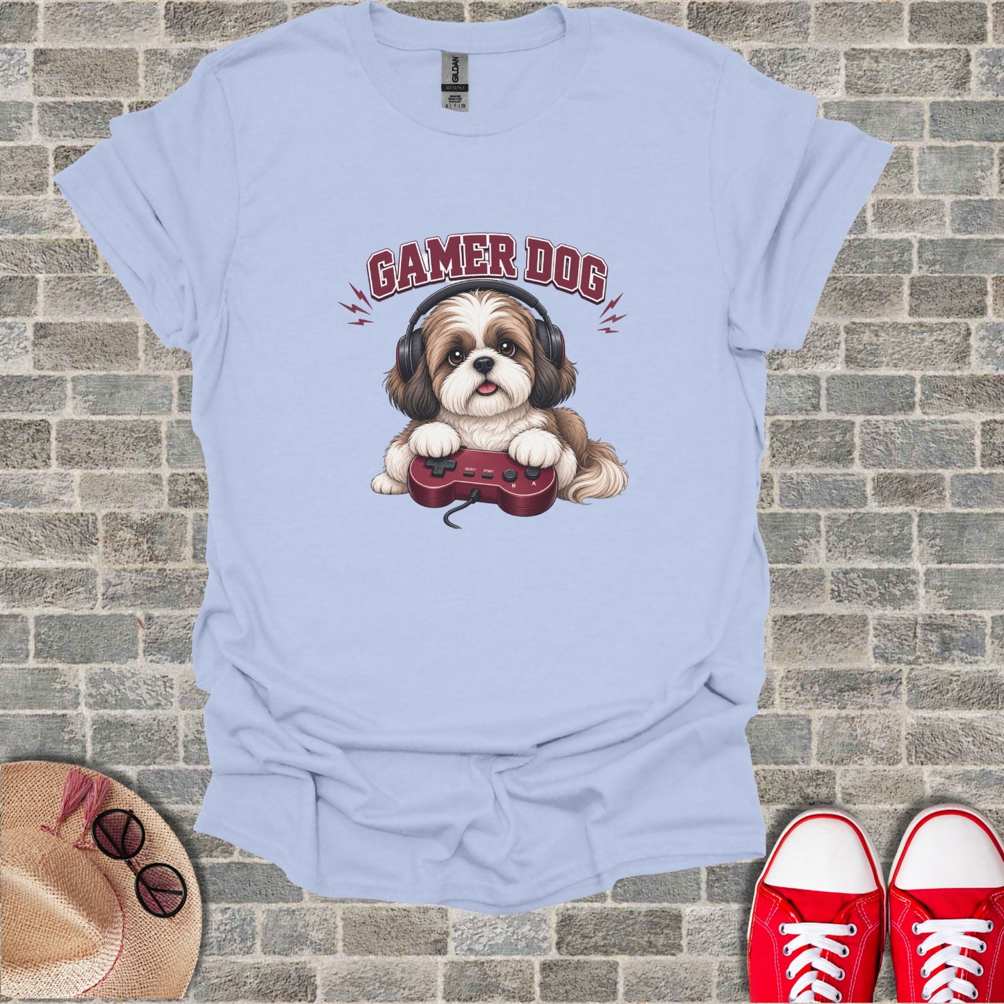 Light blue t-shirt with cartoon gamer dog holding a video game controller.