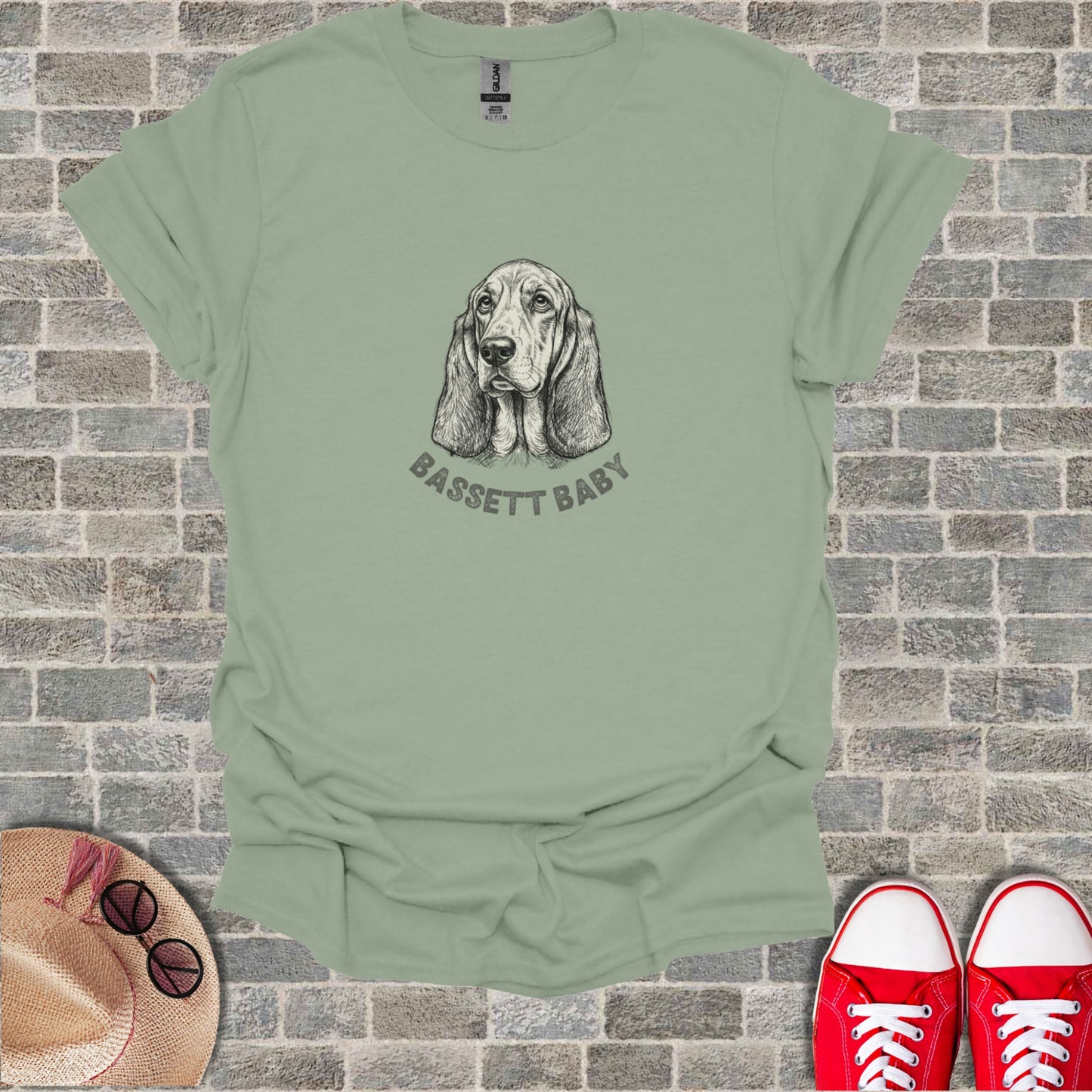 Light sage t-shirt with a sketch of a Basset Hound and "BASSET BABY" text.