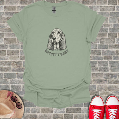 Light sage t-shirt with a sketch of a Basset Hound and "BASSET BABY" text.