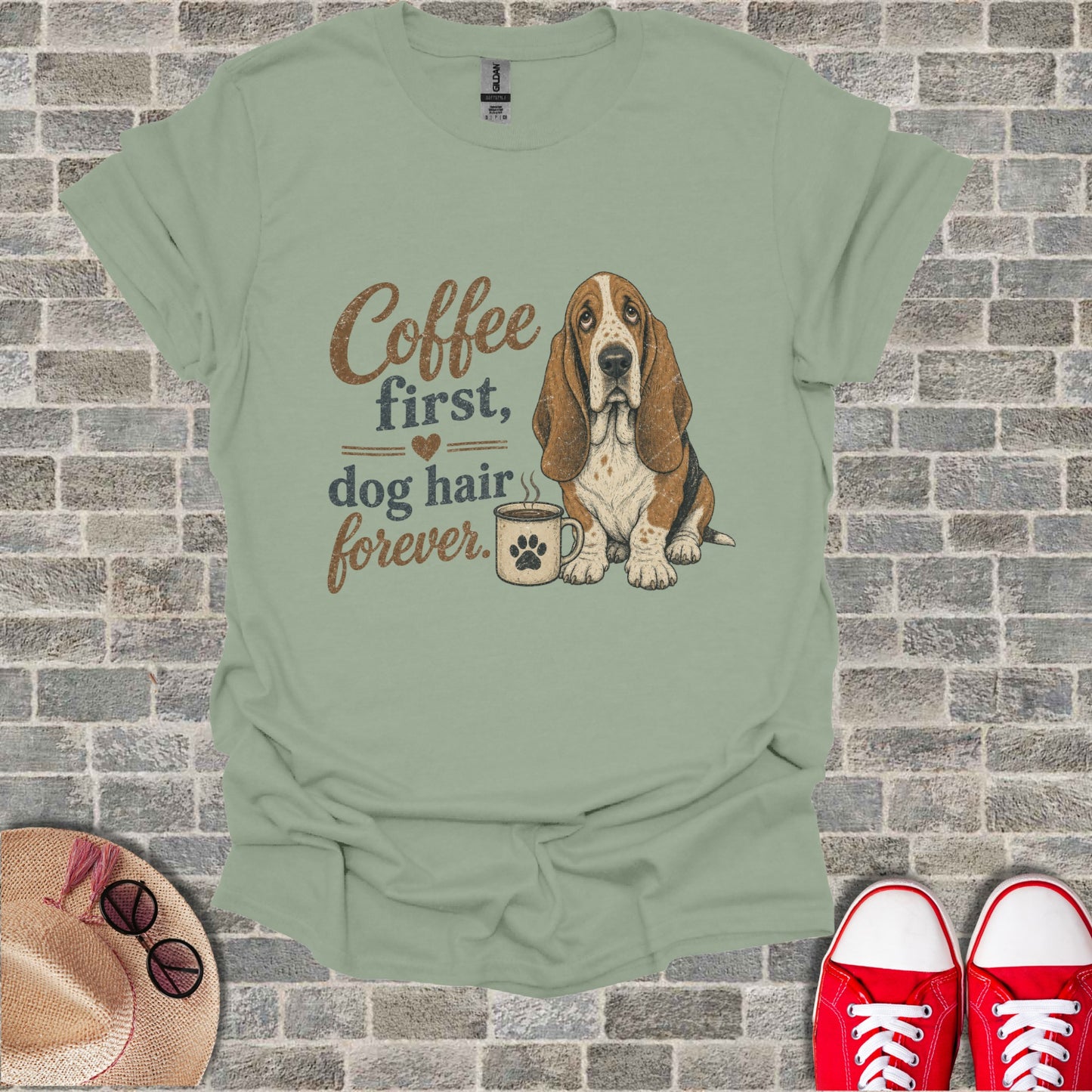 Sage t-shirt with a Basset Hound and coffee graphic and text "Coffee first, dog hair forever".