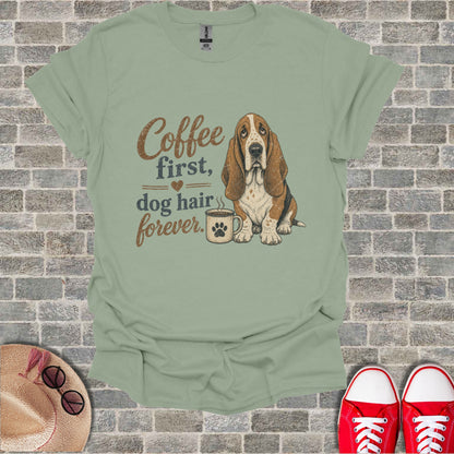 Sage t-shirt with a Basset Hound and coffee graphic and text "Coffee first, dog hair forever".