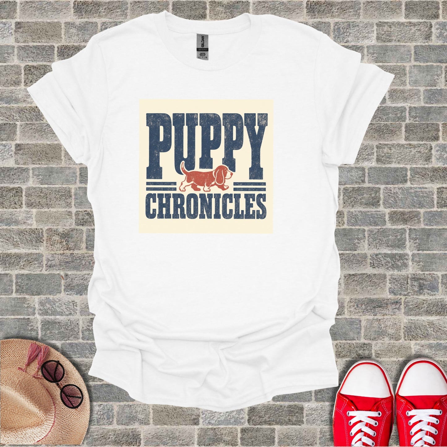 White t-shirt with "PUPPY CHRONICLES" text and a dachshund illustration.