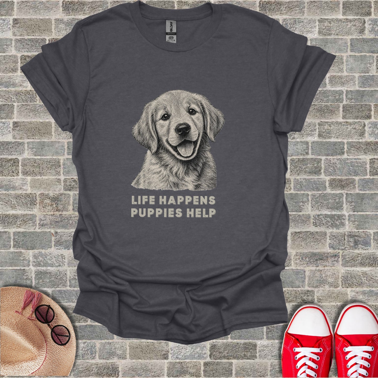 Dark grey t-shirt with sketch of a happy puppy and text "LIFE HAPPENS PUPPIES HELP".