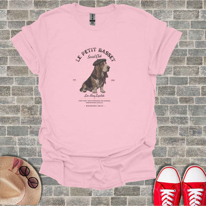 Pink t-shirt with "Le Petit Basset Social Club" and basset hound graphic.