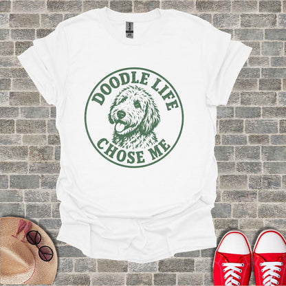White t-shirt with green circular graphic of a doodle dog and text reading "Doodle Life Chose Me".