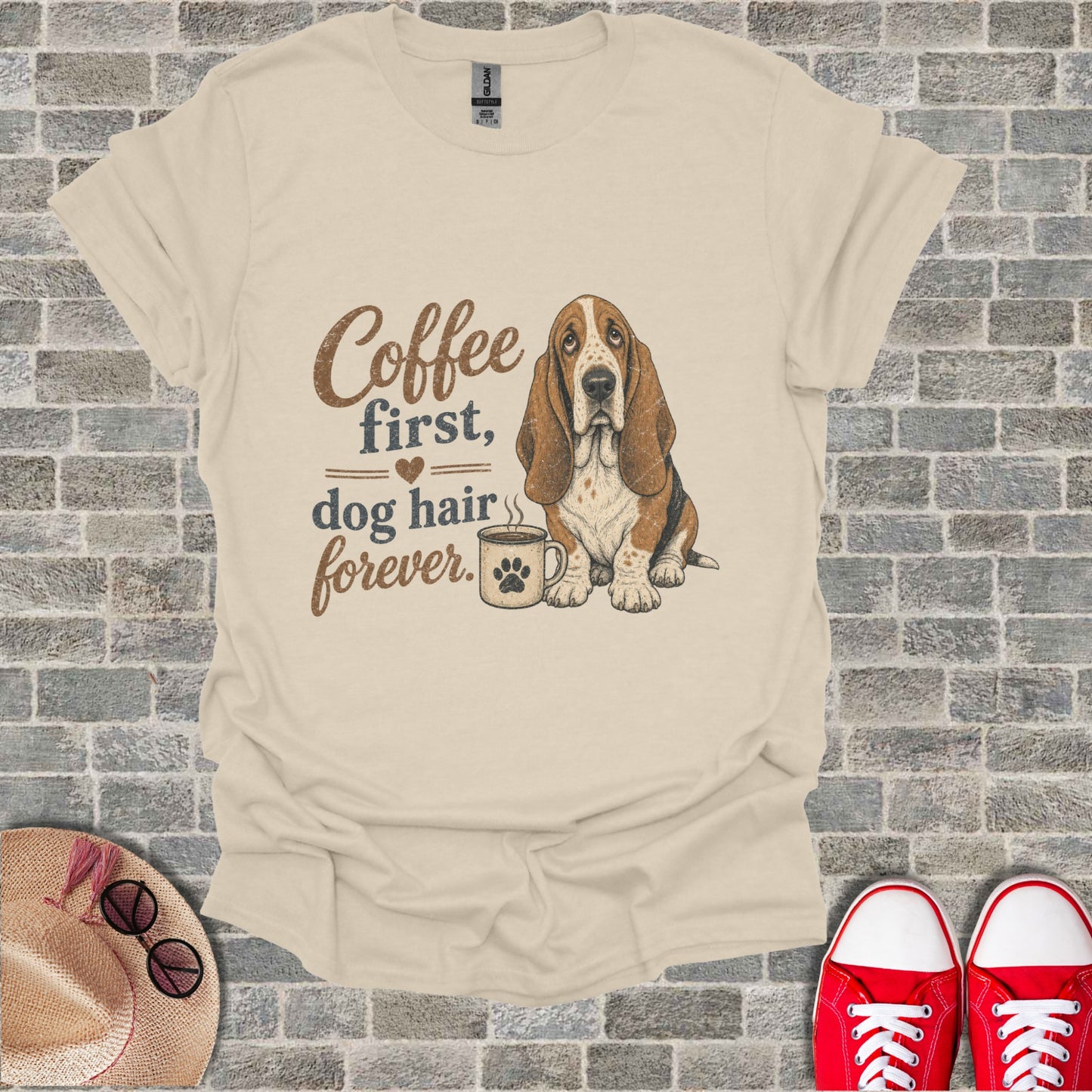 Basset Hound sits near a coffee mug with text: "Coffee first, dog hair forever."