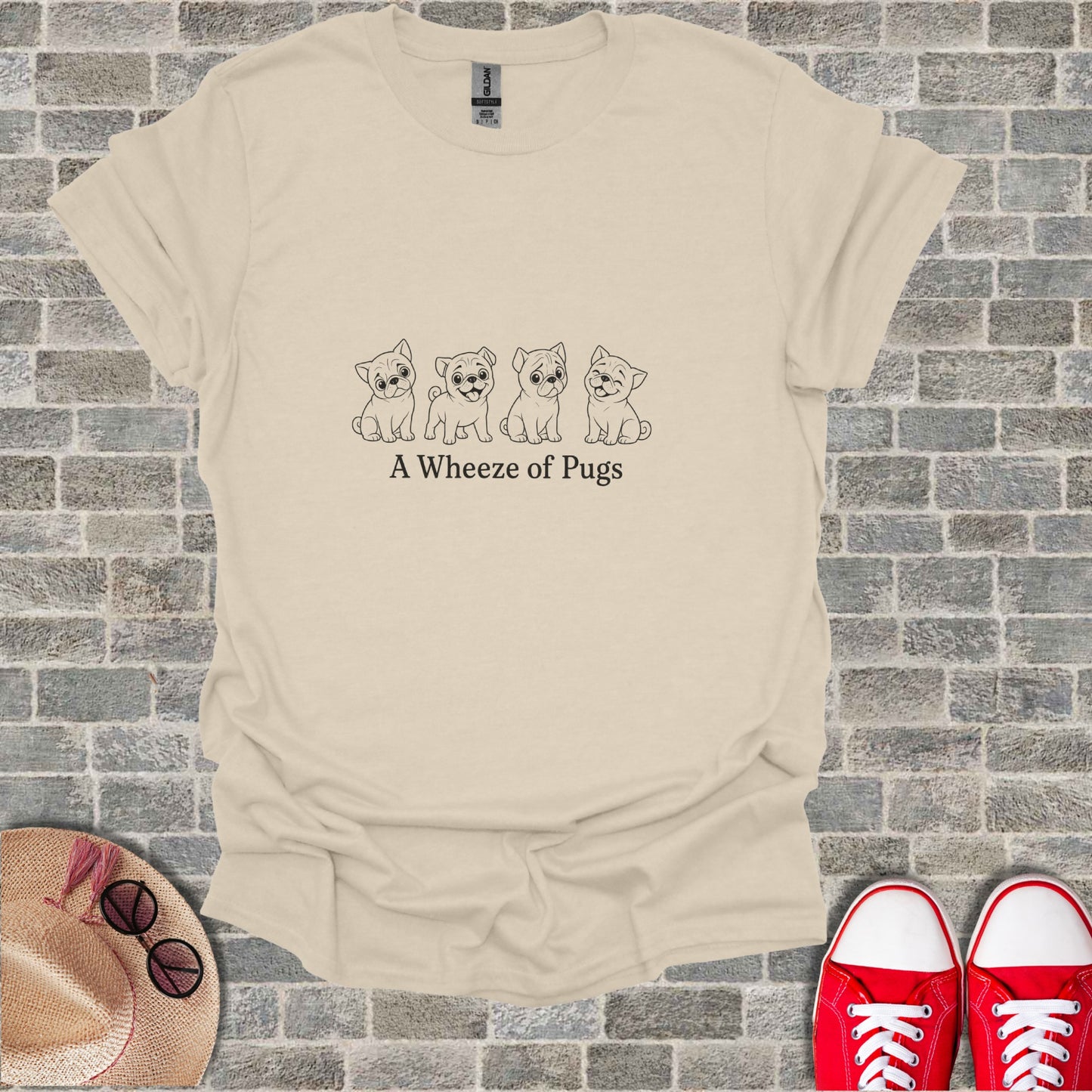 Beige t-shirt with cartoon pugs and "A Wheeze of Pugs" text.