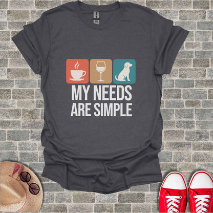 Dark gray t-shirt with coffee, wine, and dog icons and text "MY NEEDS ARE SIMPLE".