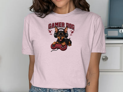 Pink t-shirt featuring a chihuahua wearing headphones and holding a video game controller.