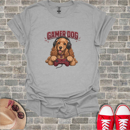 Cocker spaniel wearing headphones holds a video game controller.