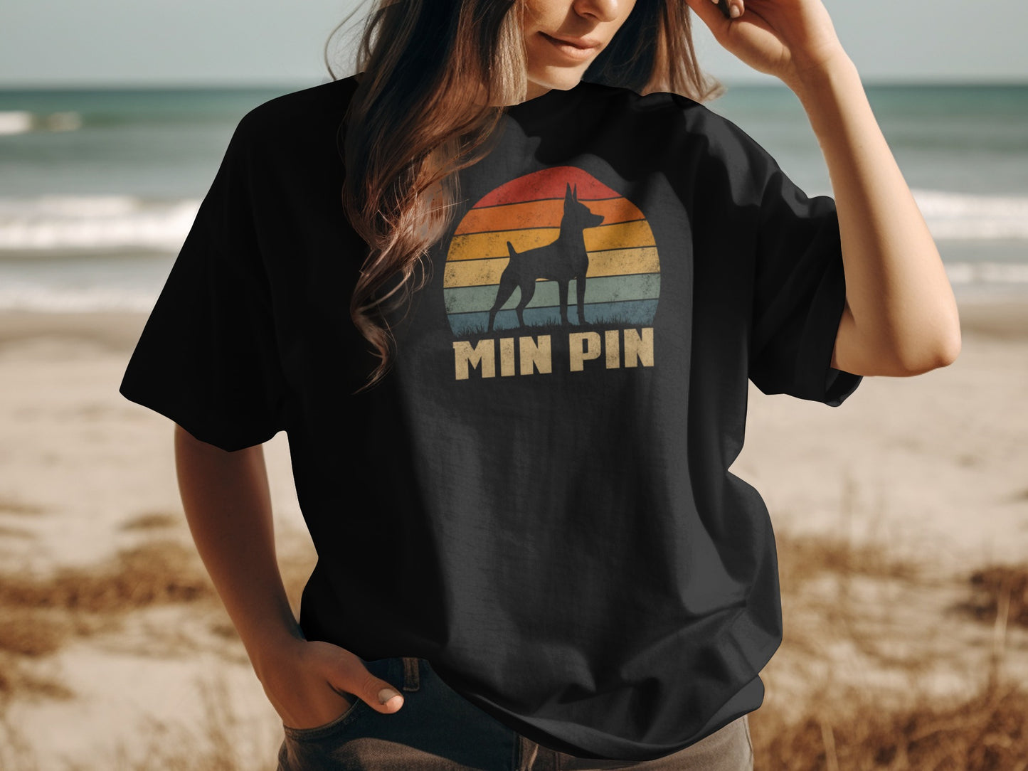 Black t-shirt with "MIN PIN" text and a Miniature Pinscher silhouette against a sunset.