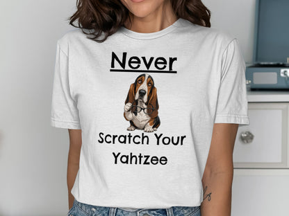 White t-shirt with "Never Scratch Your Yahtzee" and a basset hound wearing glasses.