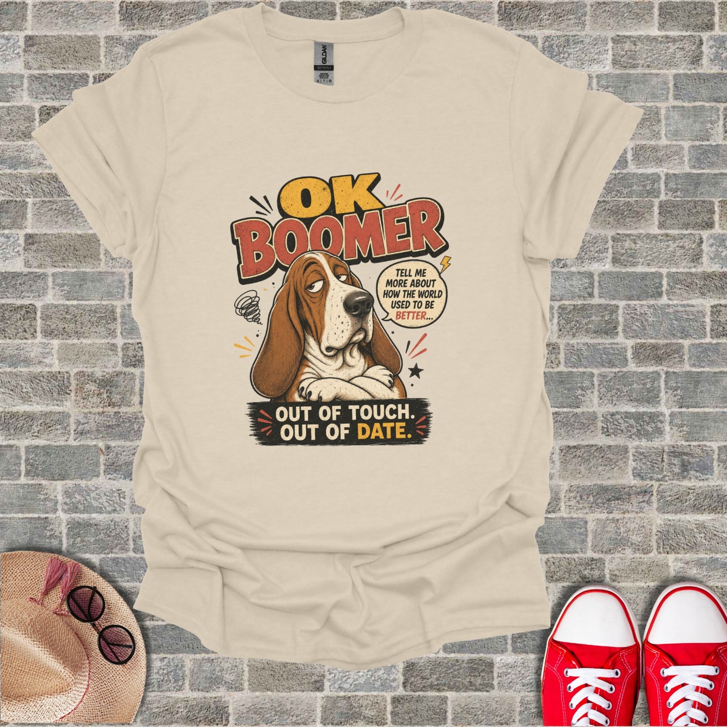 Basset hound wearing a t-shirt that says "OK Boomer, out of touch, out of date."