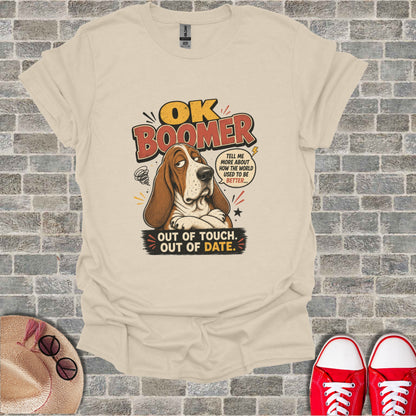 Basset hound wearing a t-shirt that says "OK Boomer, out of touch, out of date."